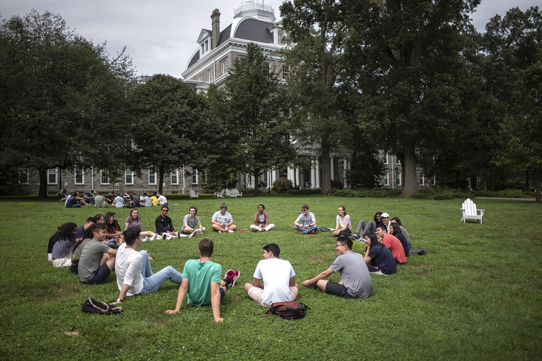 学生围成一圈在草地上在帕里什大厅前面
